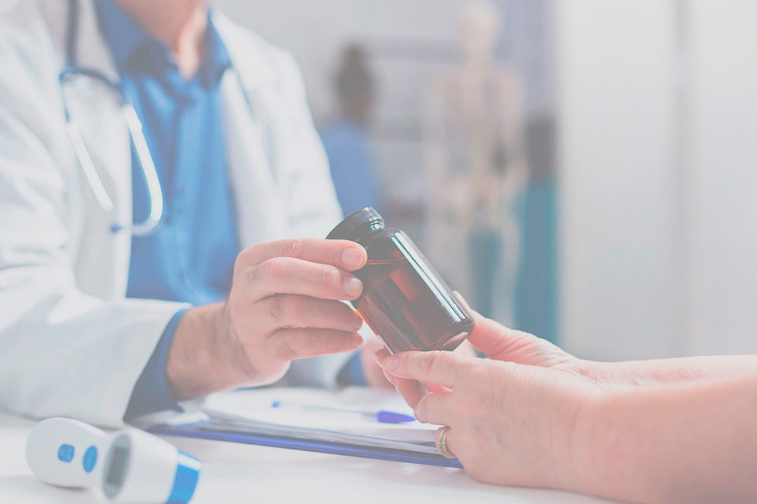 A doctor looking at medical data on a tablet in a modern hospital.